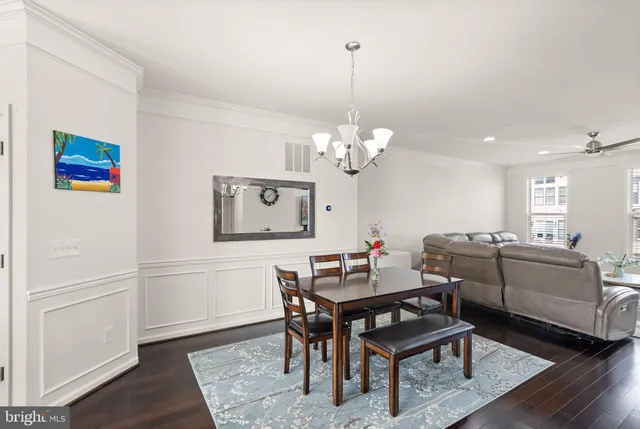 a dining room with furniture a rug and a chandelier