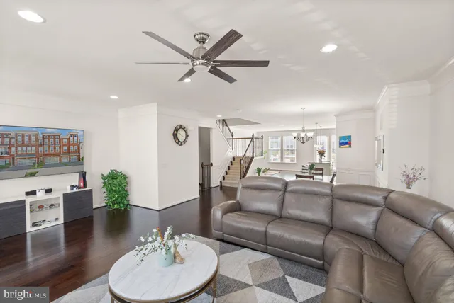 a living room with furniture and a view of kitchen