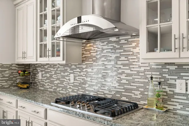 a stove top oven sitting inside of a kitchen
