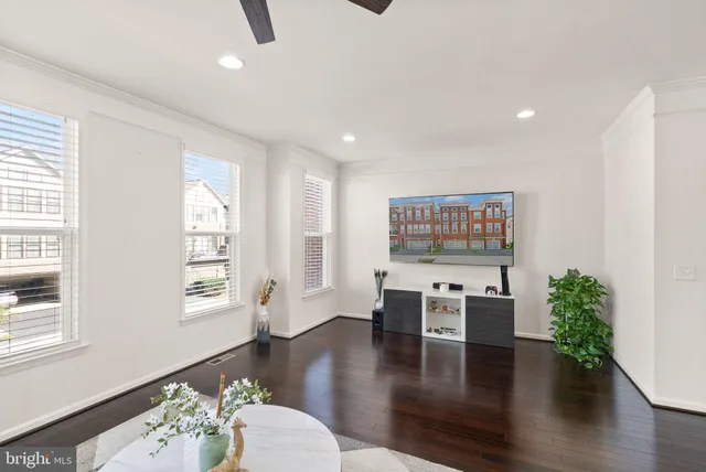 a living room with furniture a window and wooden floor