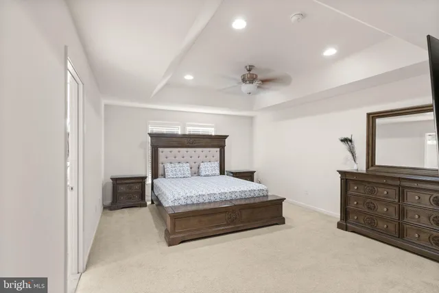 a bathroom with a granite countertop tub sink and mirror