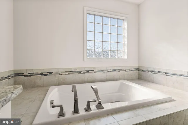 a bathroom with a granite countertop sink mirror and shower