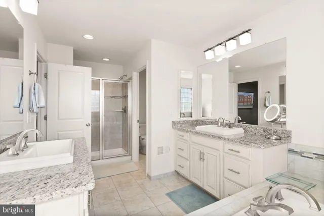 a bathroom with a granite countertop sink a mirror and vanity
