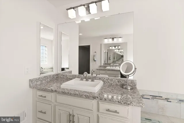 a bathroom with a glass shower door