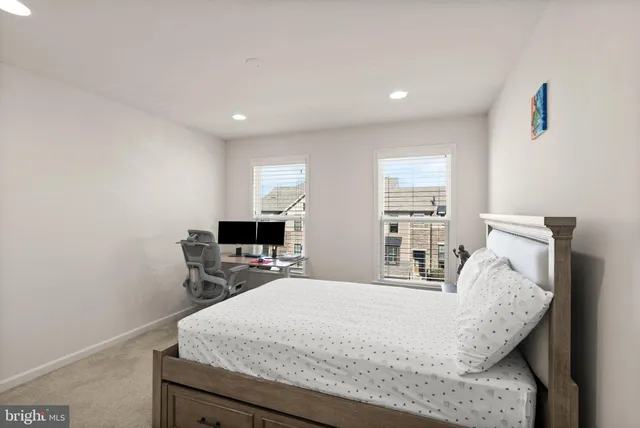 a bedroom with a bed a desk and chair