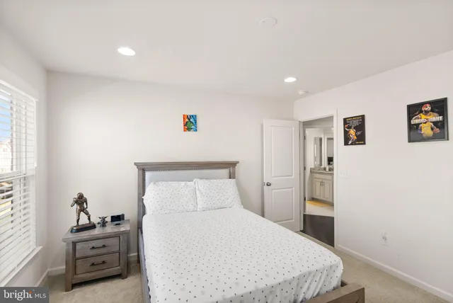 a bathroom with a granite countertop double vanity sink mirror and toilet