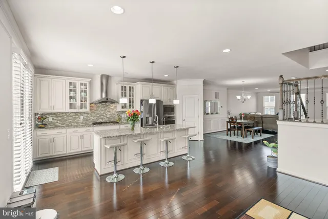 a kitchen with white cabinets and counter space