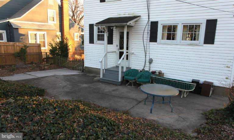 702 Murdock Road Baltimore, MD 21212 - Photo 2 of 25 a view of a patio with table and chairs with wooden fence