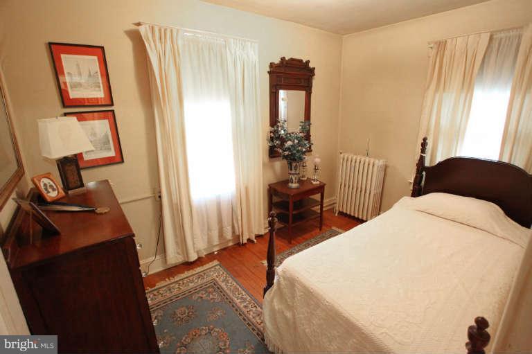 702 Murdock Road Baltimore, MD 21212 - Photo 13 of 25 a bedroom with a bed and a mirror