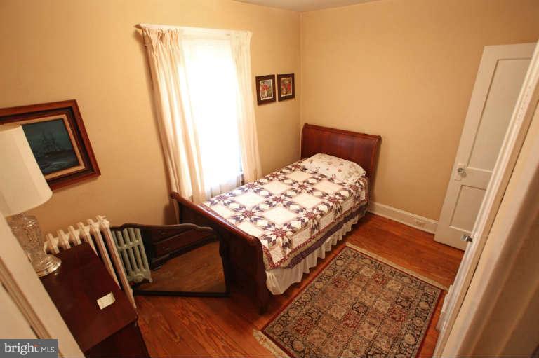 702 Murdock Road Baltimore, MD 21212 - Photo 16 of 25 a bed sitting in a bedroom next to a window