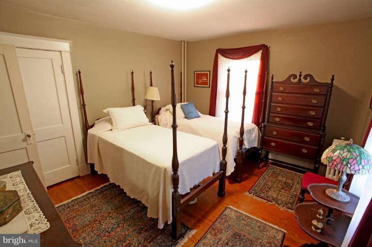 702 Murdock Road Baltimore, MD 21212 - Photo 17 of 25 a bedroom with a bed and wooden floor