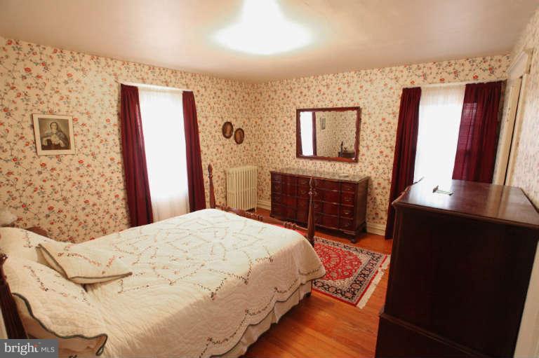 702 Murdock Road Baltimore, MD 21212 - Photo 20 of 25 a bedroom with a bed and a bathroom