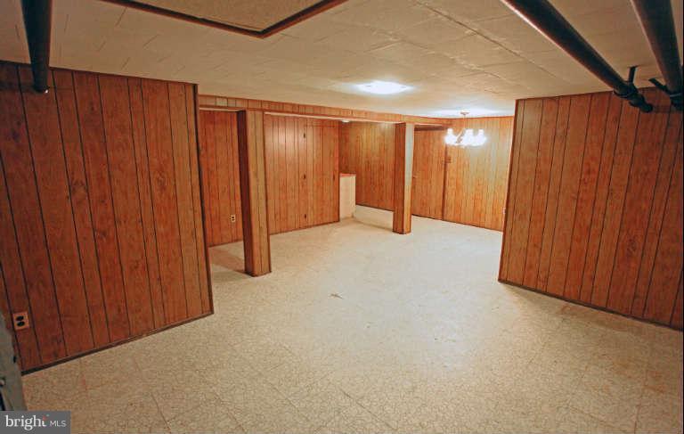 702 Murdock Road Baltimore, MD 21212 - Photo 22 of 25 an empty room with wooden walls