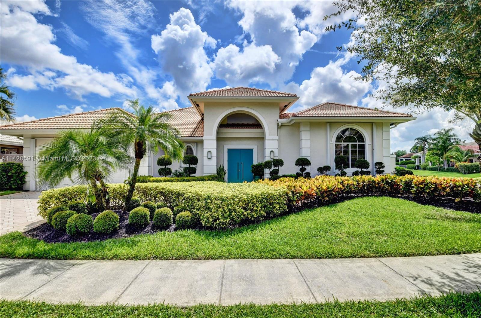 6398 Northwest 32nd Terrace Boca Raton, FL 33496 - Photo 1 of 45 a front view of a house with a garden