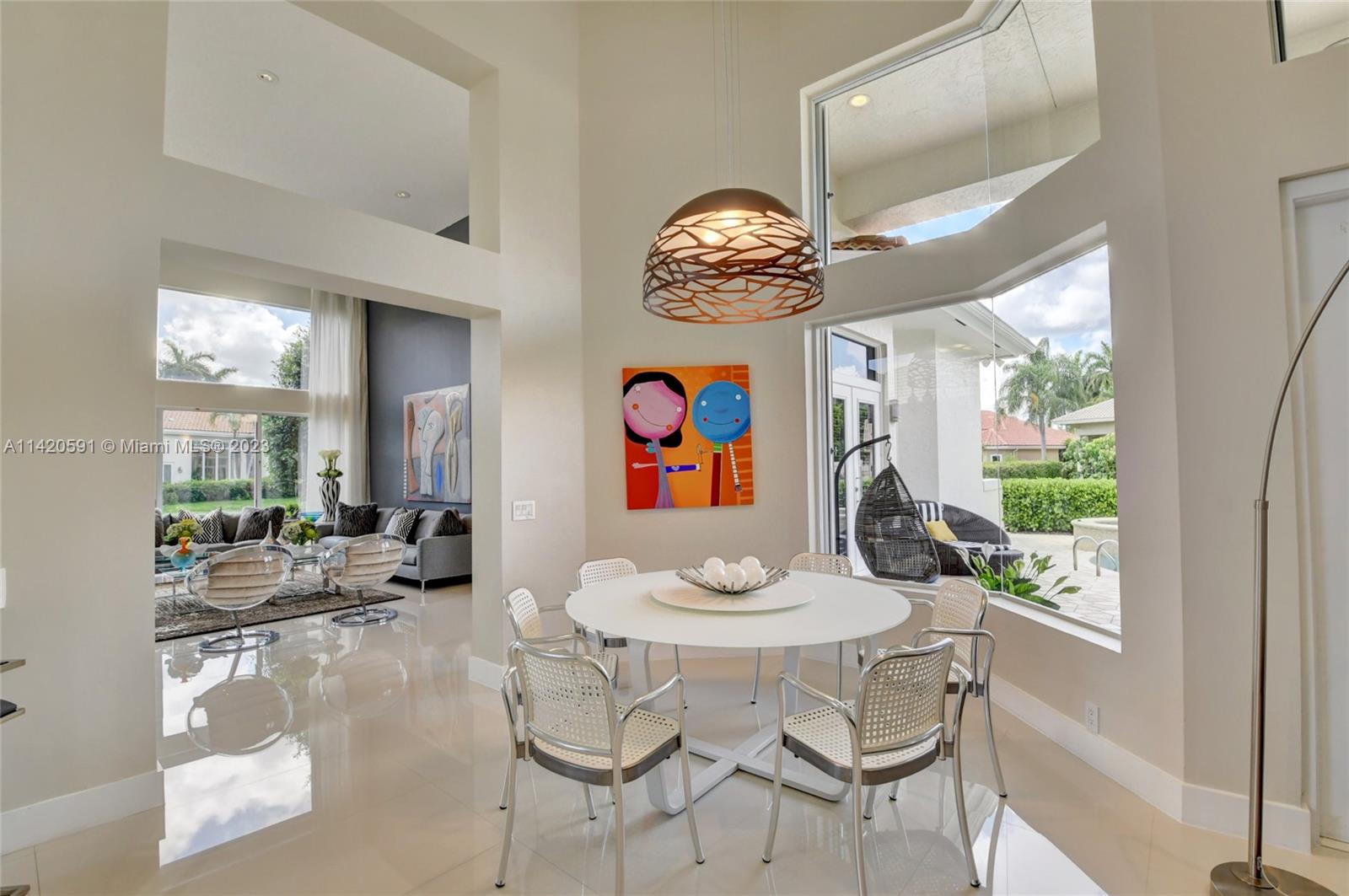 6398 Northwest 32nd Terrace Boca Raton, FL 33496 - Photo 11 of 45 a view of a dining room with furniture large windows and wooden floor