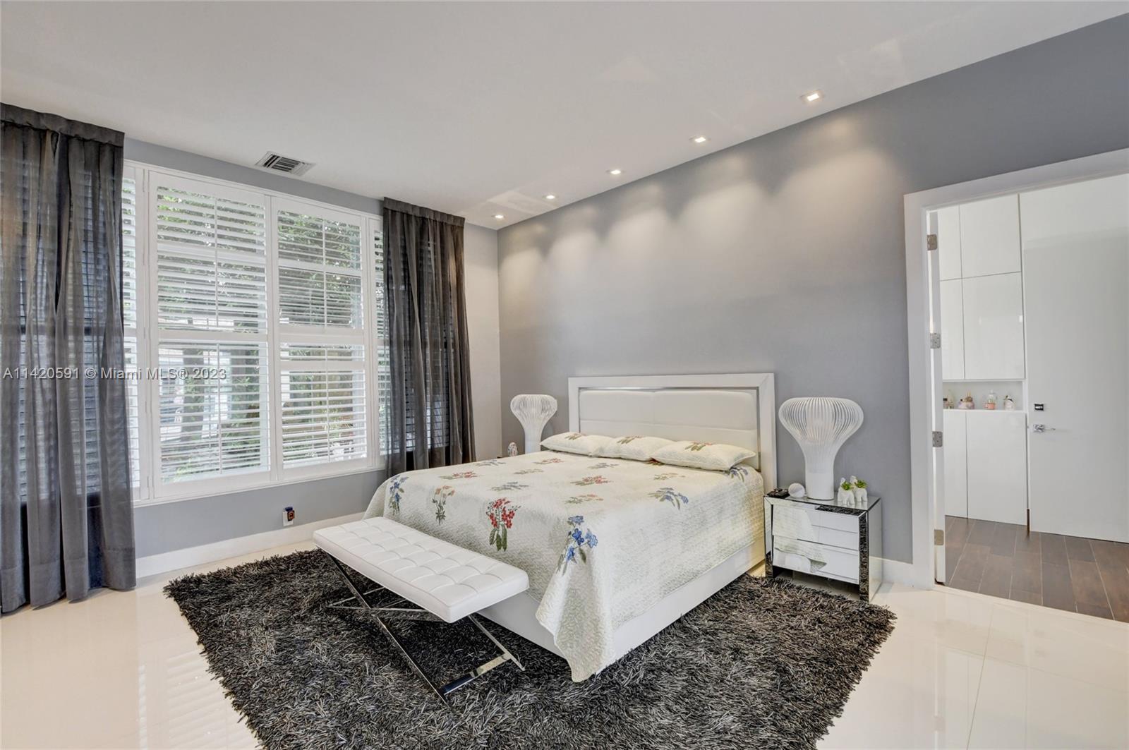 6398 Northwest 32nd Terrace Boca Raton, FL 33496 - Photo 20 of 45 a bed sitting in a bedroom next to a window