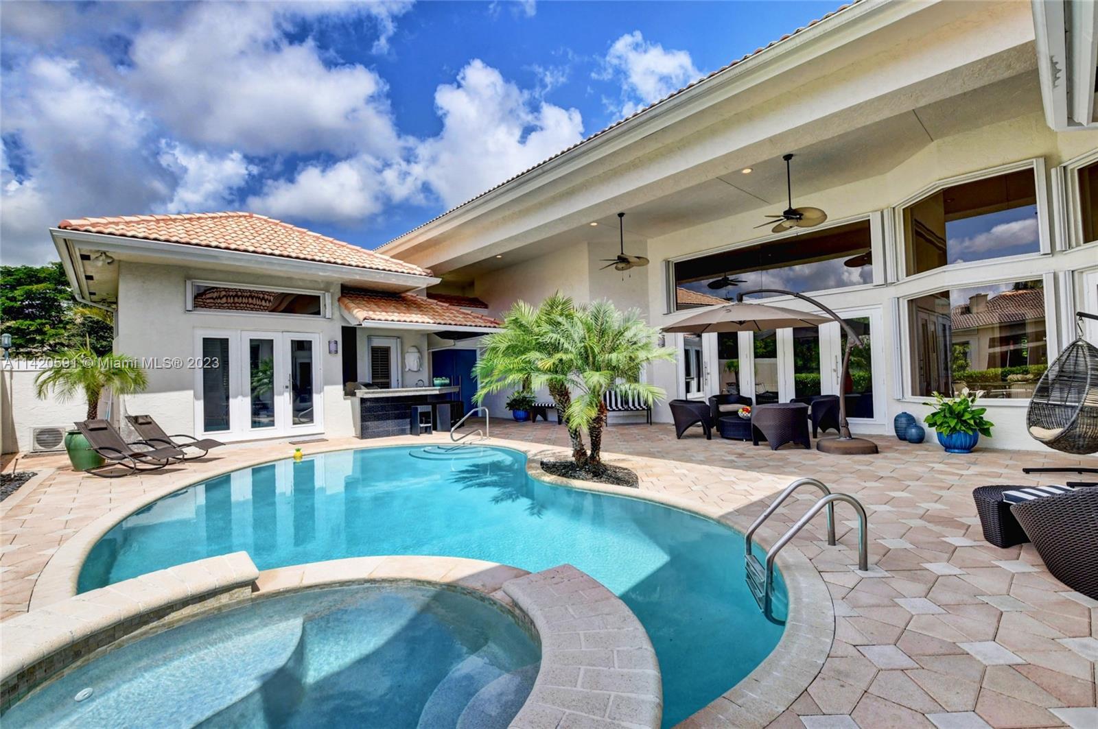 6398 Northwest 32nd Terrace Boca Raton, FL 33496 - Photo 5 of 45 a view of a house with backyard porch and sitting area