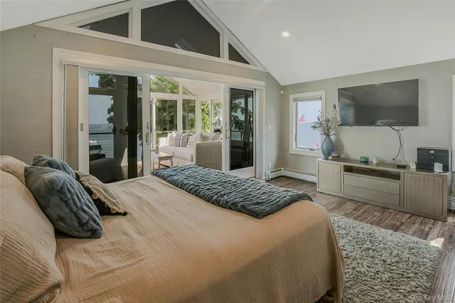 a bedroom with a large bed and a flat screen tv