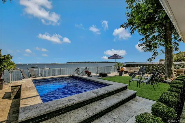 a view of a backyard with sitting area