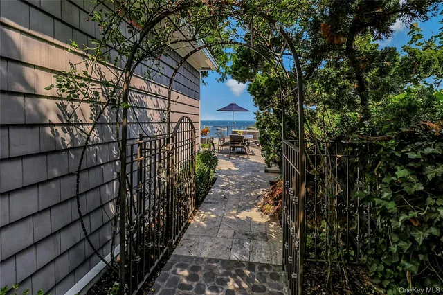 a path view of a house with a tree
