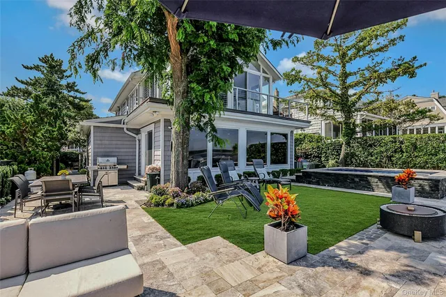 a view of a house with backyard sitting area and garden