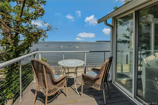 a balcony with table and chairs