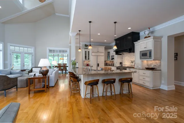a large kitchen with lots of counter and chairs