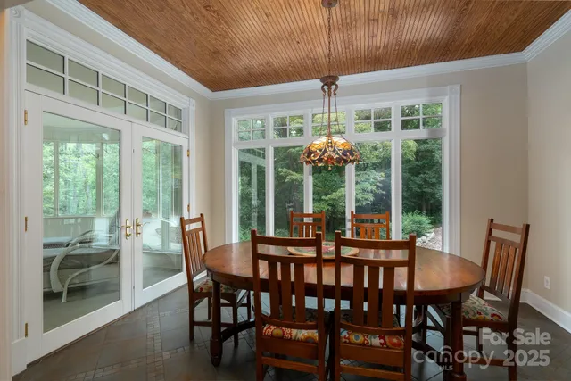 a view of a dining room with furniture wooden floor and chandelier