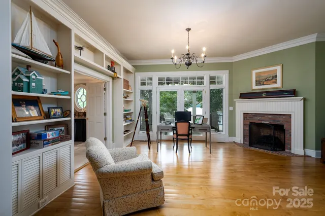 a view of a livingroom with furniture fire place and wooden floor