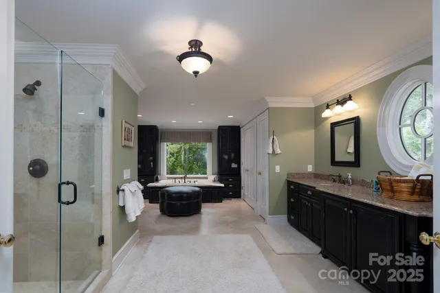 a large bathroom with a double vanity sink a large mirror and a shower