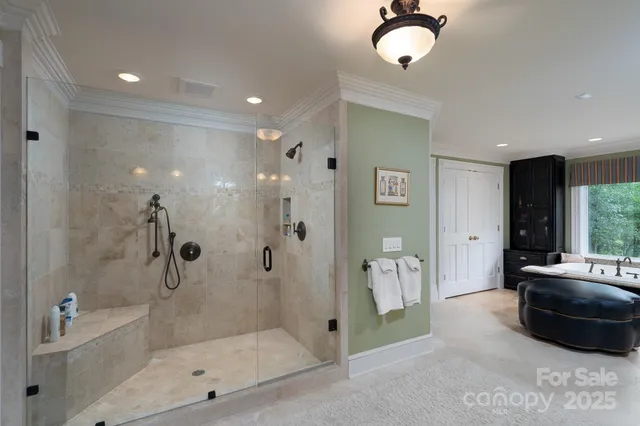 a bathroom with a tub shower and mirror