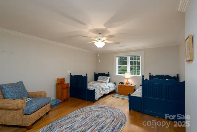 a bedroom with furniture and wooden floor