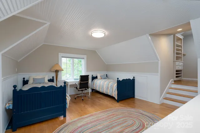 a bedroom with furniture and a wooden floor