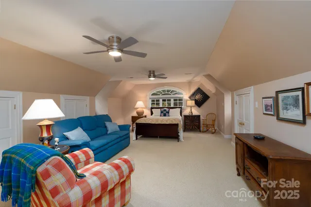 a bedroom with furniture and a chandelier
