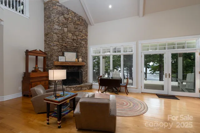 a living room with fireplace furniture and a floor to ceiling window