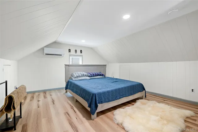 a bedroom with a bed and a lamp on table