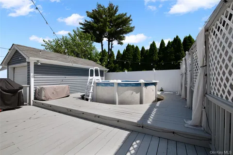 a view of a terrace with couches and wooden fence