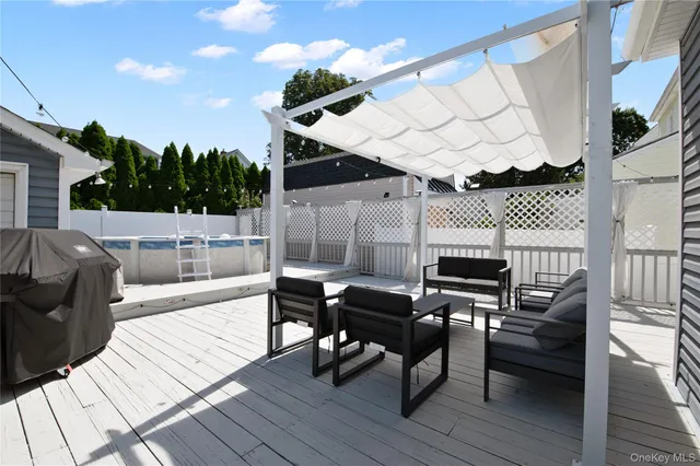 a view of a roof deck dining table and chairs with wooden floor