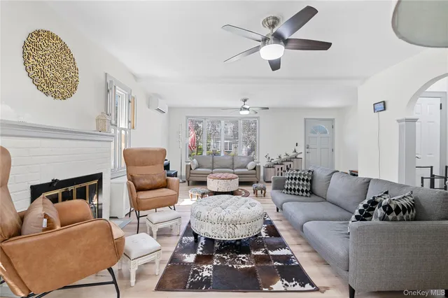 a living room with furniture ceiling fan and a fireplace