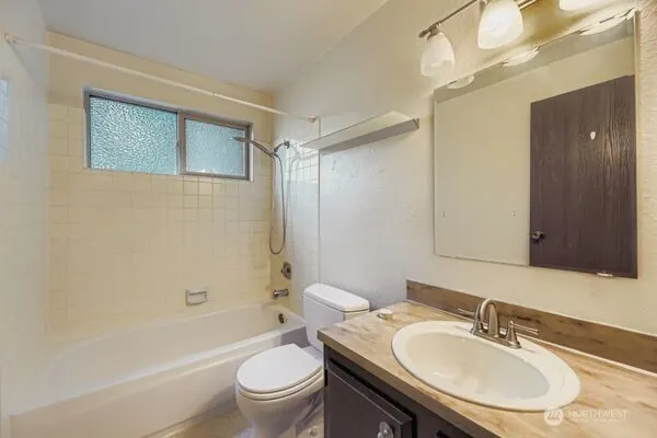 a bathroom with a sink toilet tub and shower