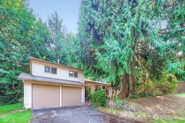 114 212th Street Southeast Bothell, WA 98021 - Photo 2 of 24 a view of house with backyard and a tree