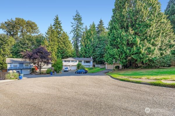 114 212th Street Southeast Bothell, WA 98021 - Photo 3 of 24 a front view of a house with a yard and trees