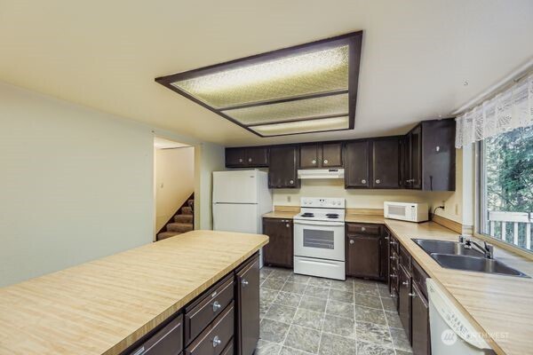 114 212th Street Southeast Bothell, WA 98021 - Photo 8 of 24 a kitchen with a stove sink and cabinets