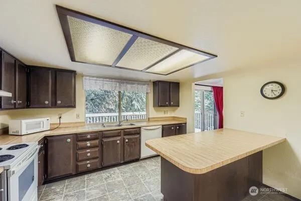 a kitchen with a sink a stove and cabinets