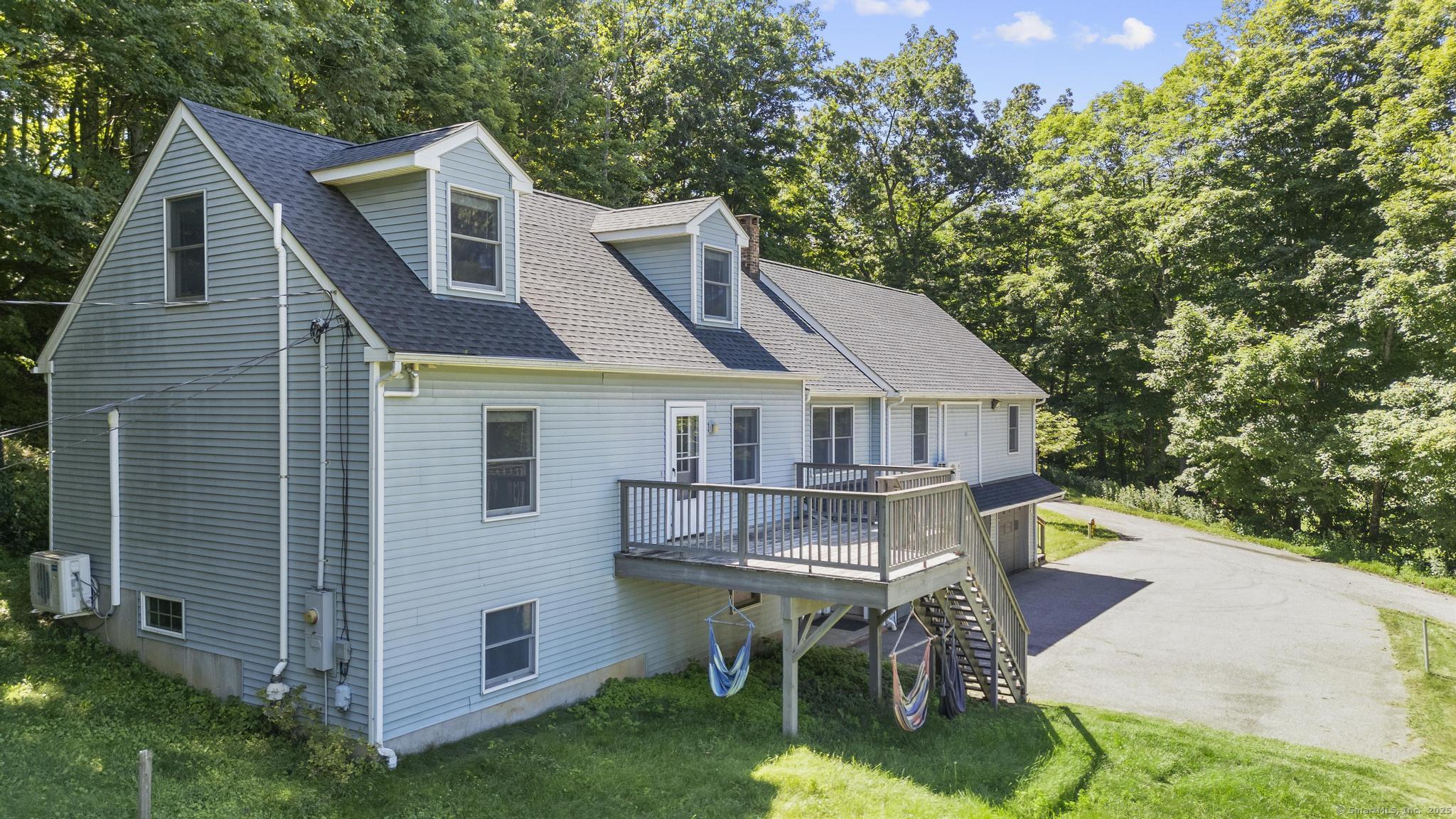 a aerial view of a house with a yard patio and furniture