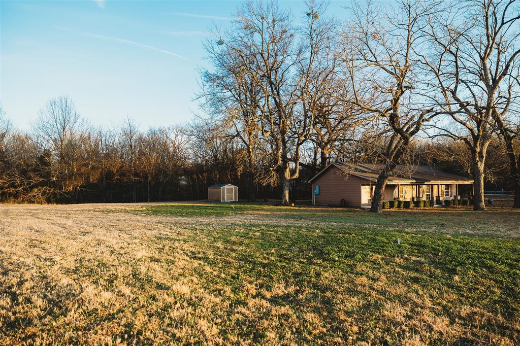 6078 East Line Road Whitewright, TX 75491 - Photo 15 of 32 View of grassy yard with a shed