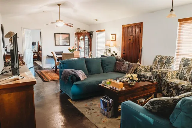 a living room with furniture fireplace and a chandelier