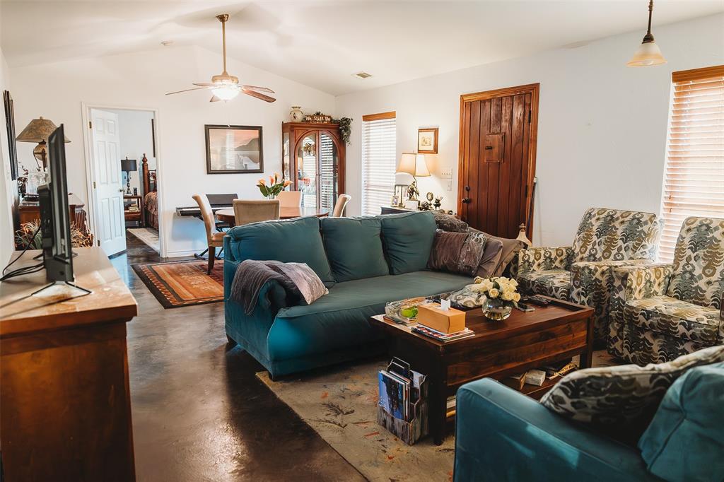 6078 East Line Road Whitewright, TX 75491 - Photo 20 of 32 Living room with lofted ceiling, finished concrete flooring, and ceiling fan