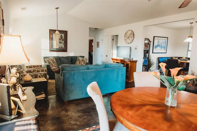 a dining room with furniture and wooden floor