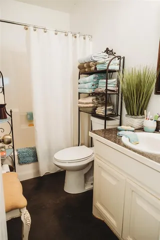 a bathroom with a sink a toilet and mirror